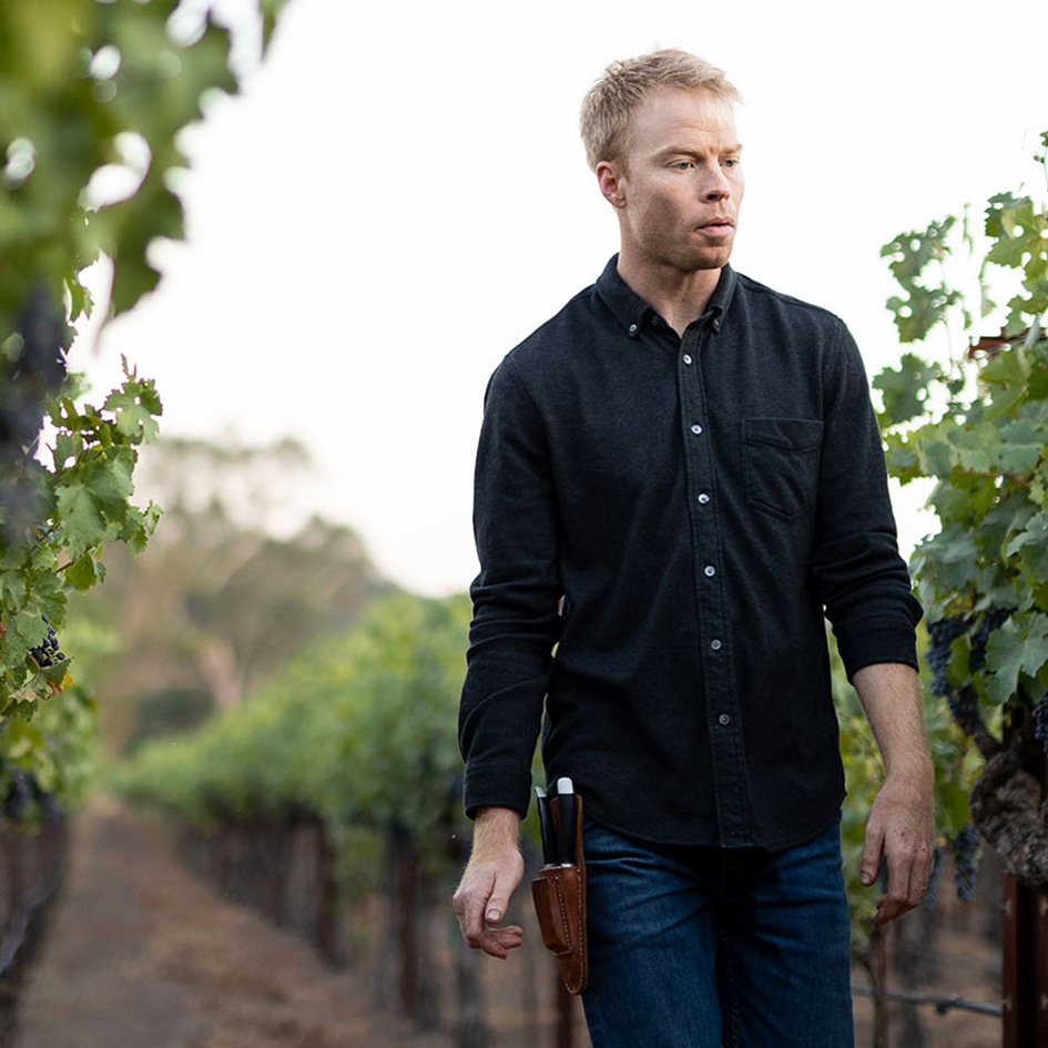 Grigsby Vineyard Winemaker, Tom Sherwood walking along vineyards in Napa Valley